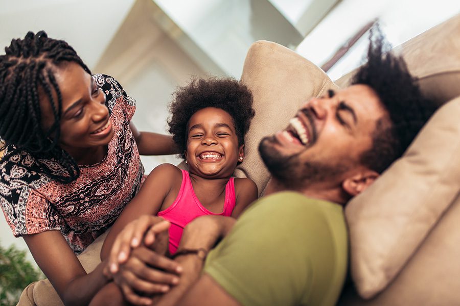 Personal Insurance - Family Spending Time Together at Home Playing on Sofa